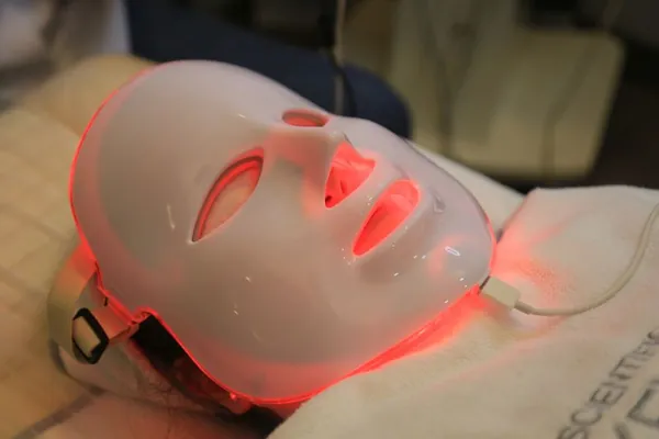 Red LED light therapy mask glowing